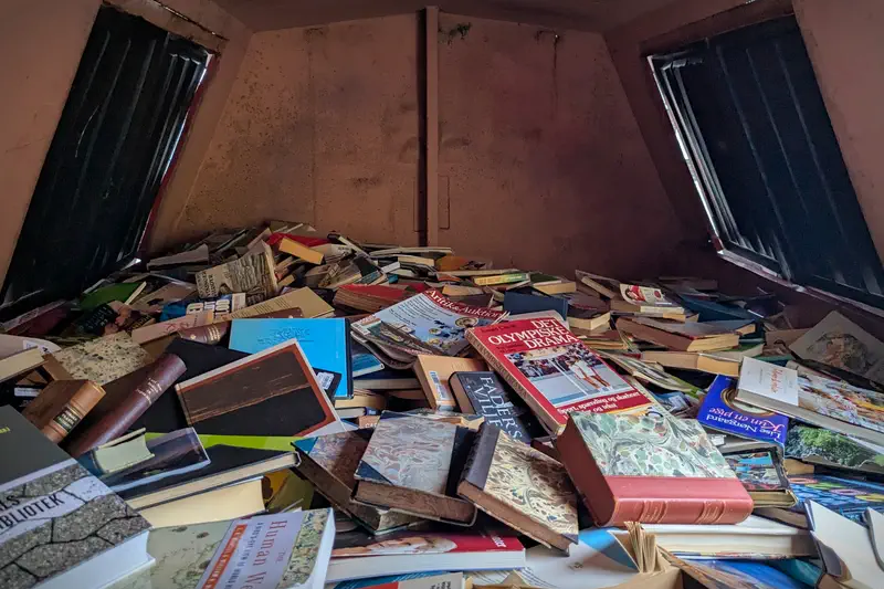 Inside a container filled with thrown out books.