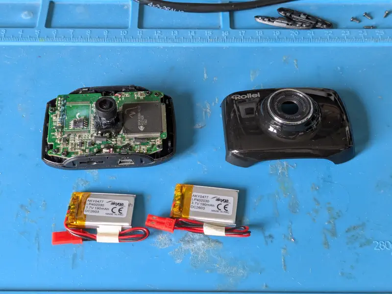 Two new lipo batteries next to the opened camera.