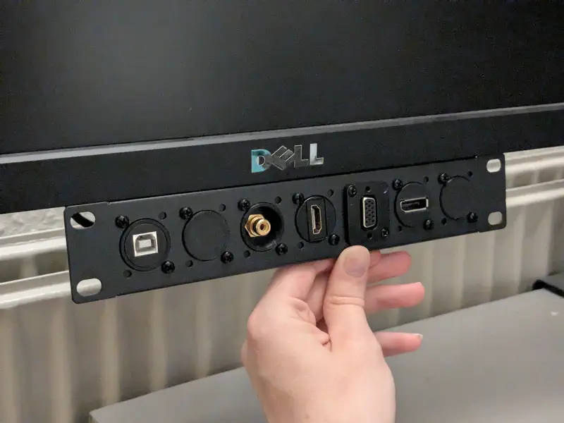 A 10 inch rack panel held underneath a monitor.